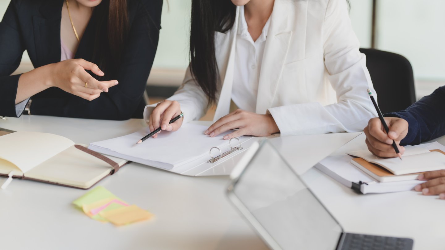 Contemporary office workers discussing documents